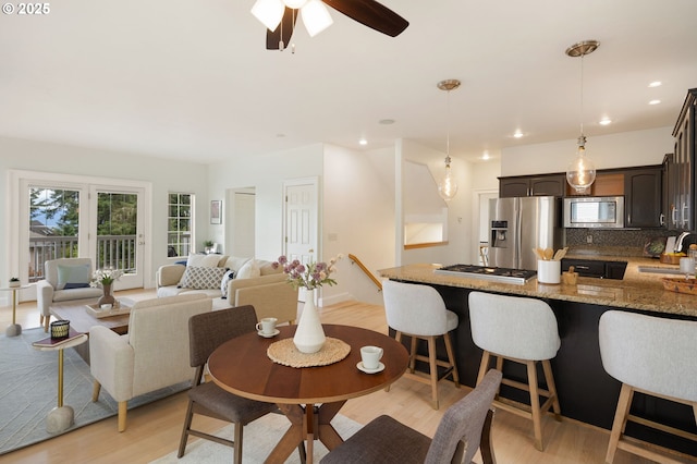 dining area with light wood-type flooring, a ceiling fan, and recessed lighting