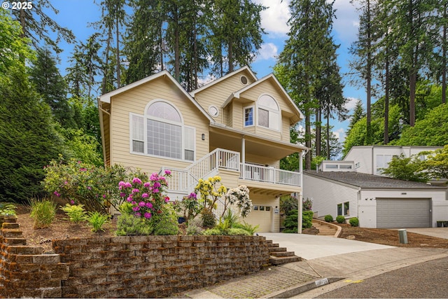 view of front of house featuring driveway, stairway, and an attached garage