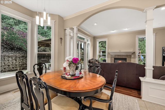 12712 SE 137th Dr, Happy Valley, OR 97086 - dining area with ornate columns, plenty of natural light, light tile patterned floors, crown molding, and a glass covered fireplace