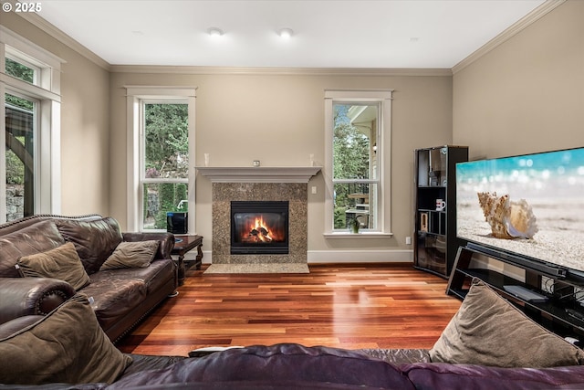 12712 SE 137th Dr, Happy Valley, OR 97086 - living area with wood finished floors, healthy amount of natural light, a premium fireplace, ornamental molding, and baseboards
