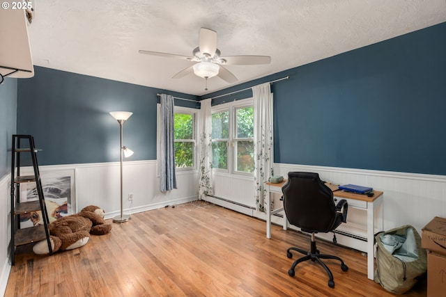 960 E Main St, Hillsboro, OR 97123 - office area featuring a wainscoted wall, wood finished floors, ceiling fan, a textured ceiling, and baseboard heating