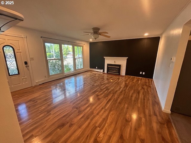 960 E Main St, Hillsboro, OR 97123 - unfurnished living room with wood finished floors, a ceiling fan, a baseboard radiator, a fireplace, and recessed lighting