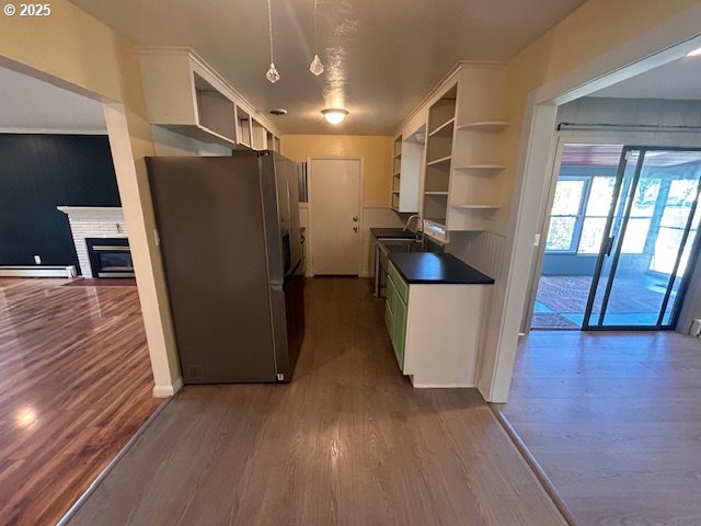 960 E Main St, Hillsboro, OR 97123 - kitchen featuring stainless steel fridge with ice dispenser, open shelves, a baseboard heating unit, dark countertops, and dark wood finished floors