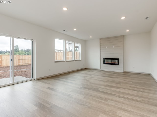 360 NW 29th Way, Battle Ground, WA 98604 - unfurnished living room featuring light wood-style flooring, recessed lighting, baseboards, and a large fireplace