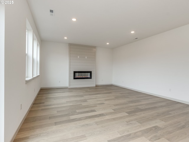360 NW 29th Way, Battle Ground, WA 98604 - unfurnished living room with recessed lighting, a large fireplace, light wood-style flooring, and baseboards