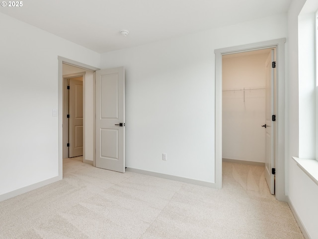 360 NW 29th Way, Battle Ground, WA 98604 - unfurnished bedroom with carpet flooring, a walk in closet, a closet, and baseboards