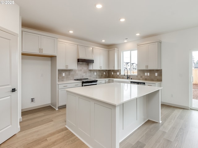 360 NW 29th Way, Battle Ground, WA 98604 - kitchen featuring a kitchen island, electric range, light wood-type flooring, backsplash, and recessed lighting