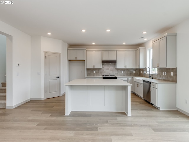 360 NW 29th Way, Battle Ground, WA 98604 - kitchen with stainless steel appliances, a sink, light countertops, tasteful backsplash, and a center island