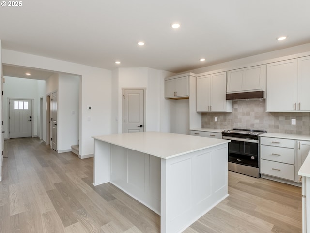 360 NW 29th Way, Battle Ground, WA 98604 - kitchen with stainless steel range with electric stovetop, light countertops, light wood finished floors, recessed lighting, and decorative backsplash
