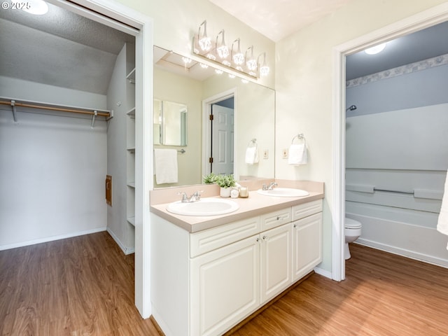 2001 E Evergreen Blvd, Vancouver, WA 98661 - bathroom featuring wood finished floors, double vanity, toilet, and shower / bathtub combination