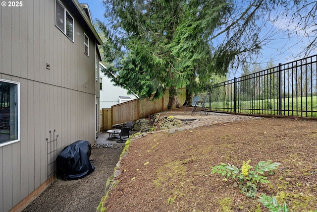 view of yard featuring a patio area and a fenced backyard