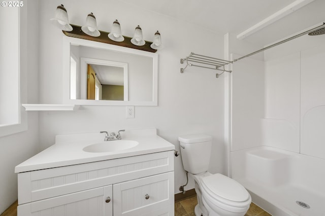 full bathroom with vanity, toilet, and a shower