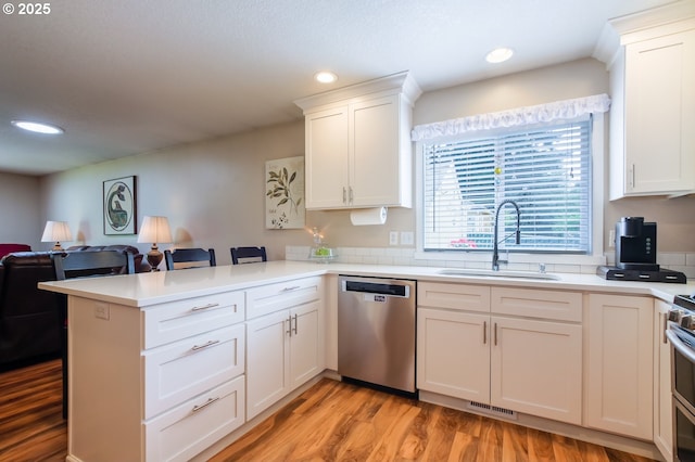 10100 NE 65th Cir, Vancouver, WA 98662 - kitchen with appliances with stainless steel finishes, a peninsula, open floor plan, white cabinetry, and recessed lighting