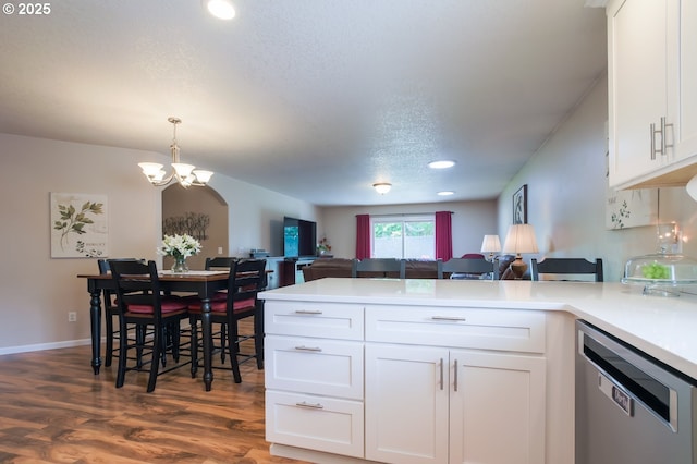 10100 NE 65th Cir, Vancouver, WA 98662 - kitchen featuring stainless steel dishwasher, open floor plan, a chandelier, a peninsula, and white cabinets