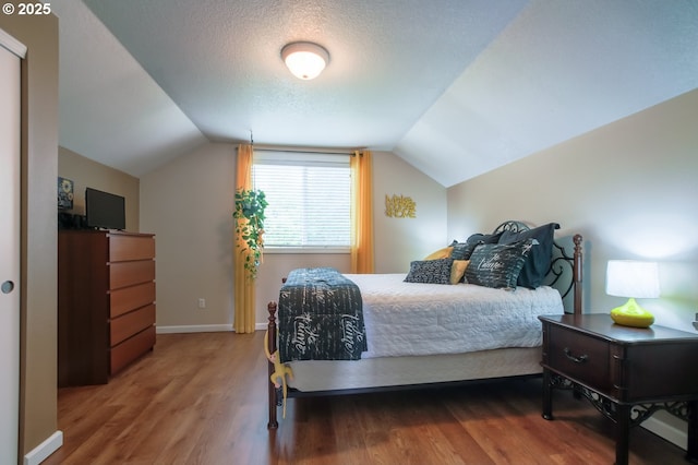 10100 NE 65th Cir, Vancouver, WA 98662 - bedroom with vaulted ceiling, wood finished floors, and a textured ceiling