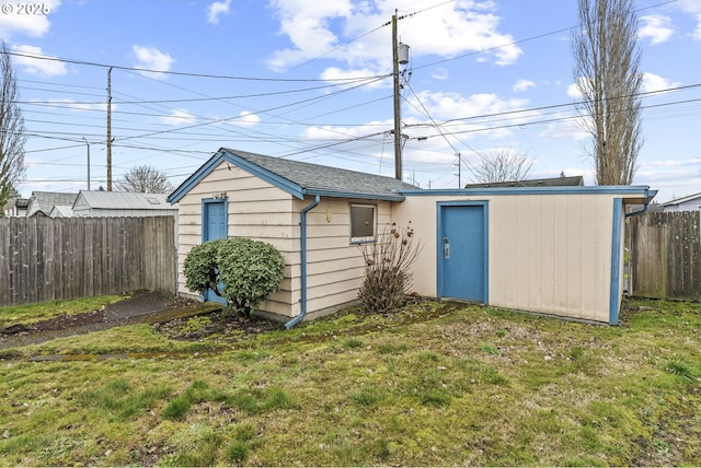 view of outdoor structure featuring an outbuilding and fence