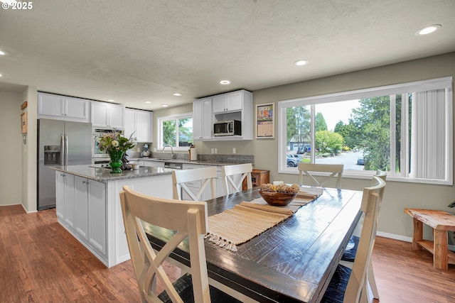 4249 SE 18th Ct, Gresham, OR 97080 - dining room featuring a textured ceiling, dark wood finished floors, and recessed lighting