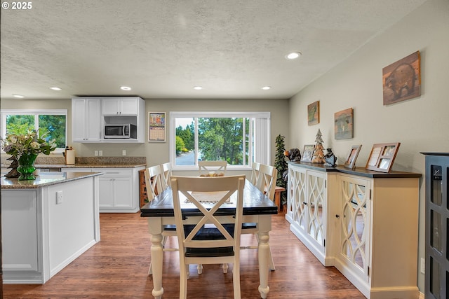 4249 SE 18th Ct, Gresham, OR 97080 - dining space featuring a textured ceiling, plenty of natural light, wood finished floors, and recessed lighting
