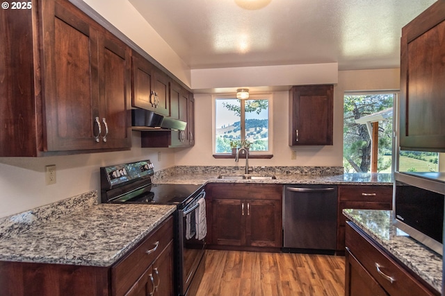 5310 Green Valley Rd, Oakland, OR 97462 - kitchen featuring stainless steel appliances, a sink, under cabinet range hood, light wood-type flooring, and light stone countertops