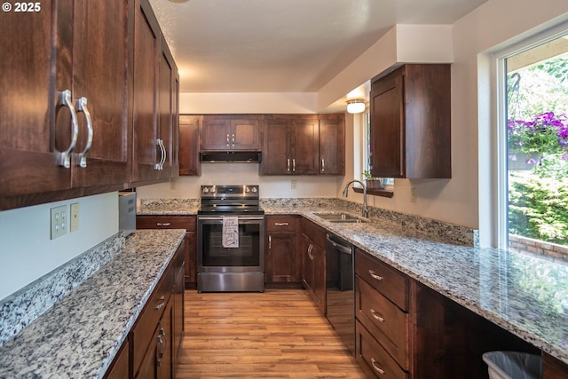 5310 Green Valley Rd, Oakland, OR 97462 - kitchen featuring appliances with stainless steel finishes, under cabinet range hood, a sink, light wood-style floors, and light stone counters