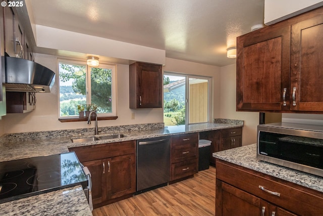 5310 Green Valley Rd, Oakland, OR 97462 - kitchen featuring stainless steel appliances, exhaust hood, a sink, light wood-style floors, and light stone countertops