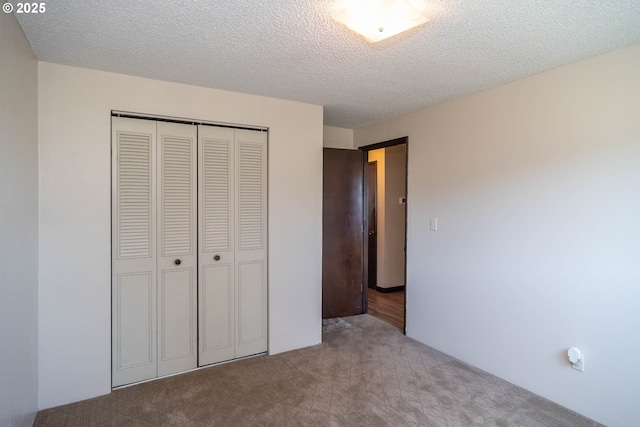 5310 Green Valley Rd, Oakland, OR 97462 - unfurnished bedroom featuring carpet flooring, a closet, and a textured ceiling