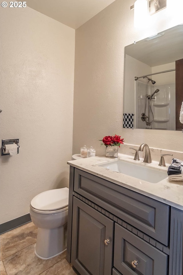 5310 Green Valley Rd, Oakland, OR 97462 - full bath with vanity, toilet, a shower, a textured wall, and baseboards