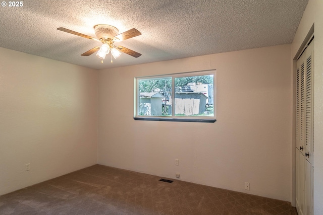 5310 Green Valley Rd, Oakland, OR 97462 - unfurnished bedroom featuring a closet, carpet flooring, a textured ceiling, and a ceiling fan