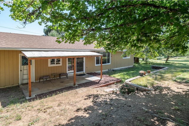 5310 Green Valley Rd, Oakland, OR 97462 - rear view of house with a shingled roof, a patio area, and a lawn