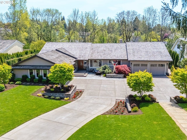 ranch-style home with concrete driveway, an attached garage, and a front yard