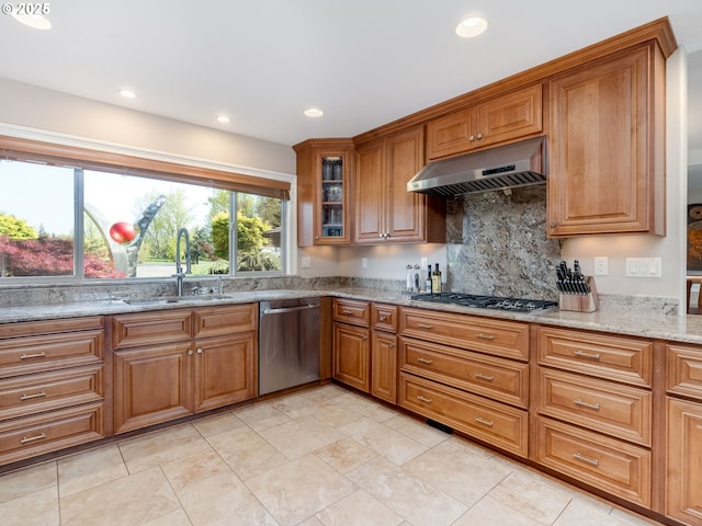 kitchen featuring a sink, appliances with stainless steel finishes, under cabinet range hood, and brown cabinets
