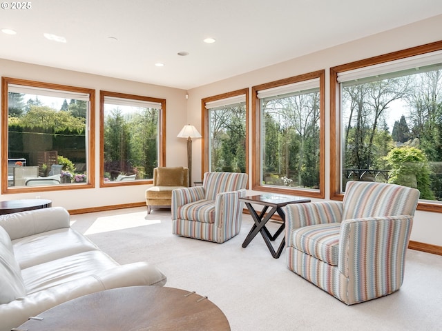 carpeted living area featuring recessed lighting, baseboards, and a wealth of natural light