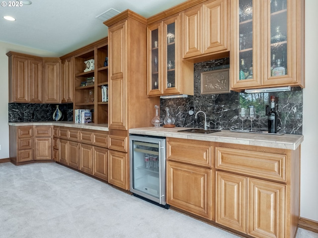 bar with decorative backsplash, light colored carpet, a sink, indoor wet bar, and beverage cooler