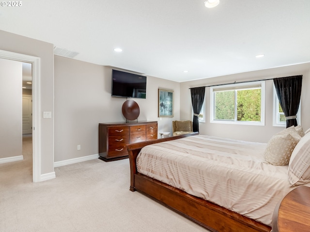 bedroom with baseboards, light carpet, recessed lighting, and visible vents