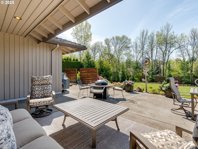 view of patio / terrace featuring outdoor dining space, a fenced backyard, and a grill