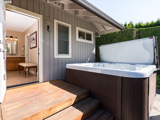 wooden deck with a hot tub