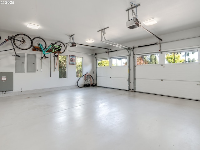 garage with a garage door opener and electric panel