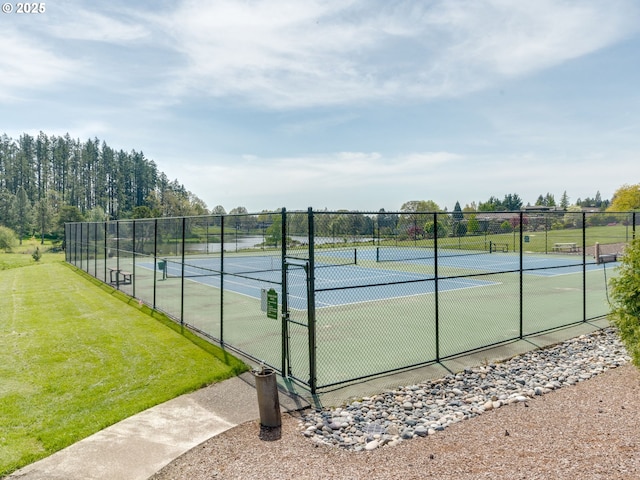 view of tennis court featuring fence