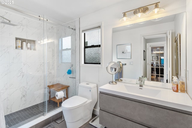 bathroom featuring vanity, toilet, and an enclosed shower