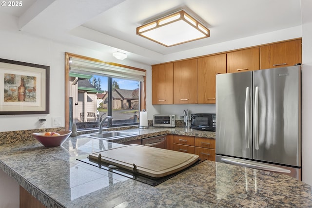 kitchen featuring sink, stainless steel fridge, and kitchen peninsula