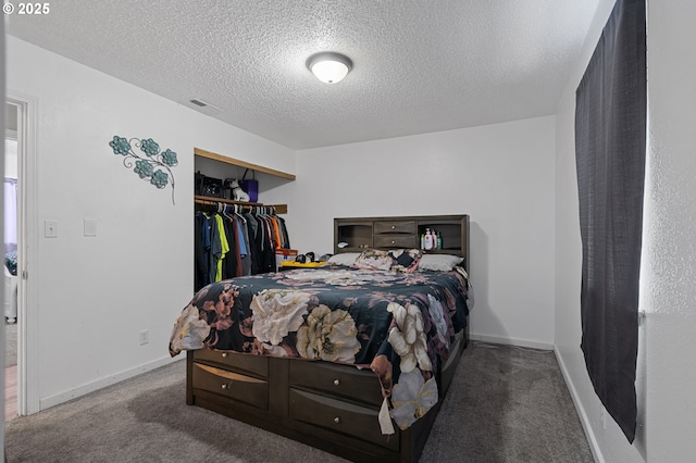 bedroom with a textured ceiling, a closet, and carpet floors