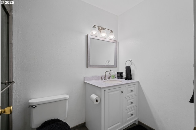 bathroom featuring toilet and vanity