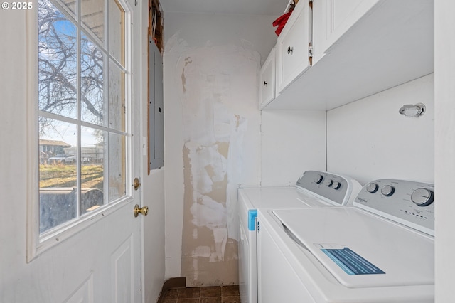 clothes washing area with separate washer and dryer and cabinets