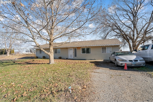 ranch-style home with a front lawn