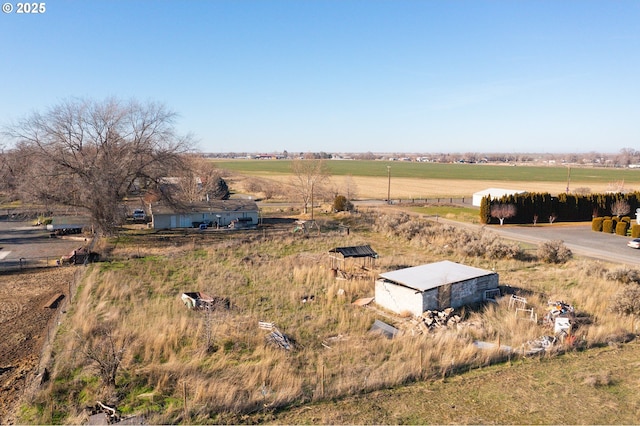 birds eye view of property with a rural view