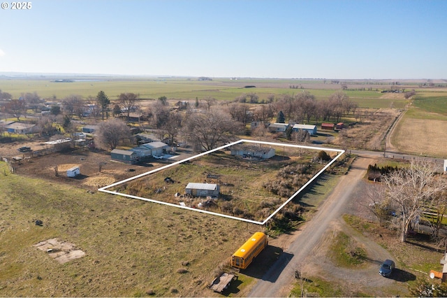 birds eye view of property with a rural view