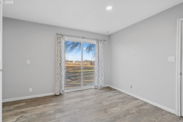 unfurnished room featuring hardwood / wood-style flooring