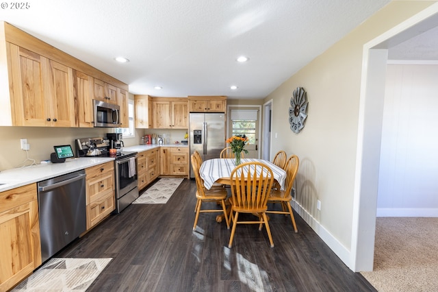 kitchen with light countertops, appliances with stainless steel finishes, and light brown cabinets