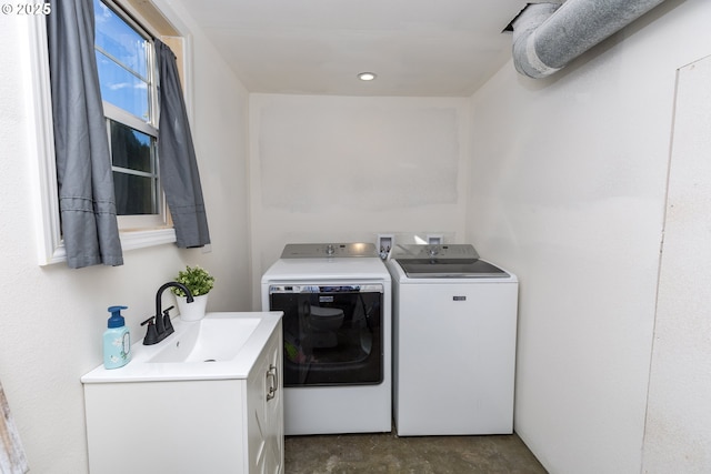 clothes washing area featuring washer and clothes dryer and a sink