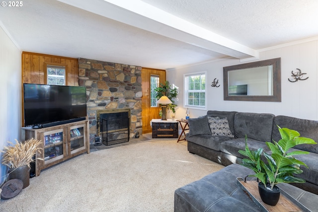 carpeted living area featuring a textured ceiling, ornamental molding, and a fireplace